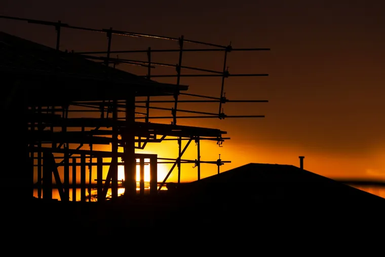 Photo of scaffolding on a house under construction at sunset, the kind of local job contractor marketing helps you win