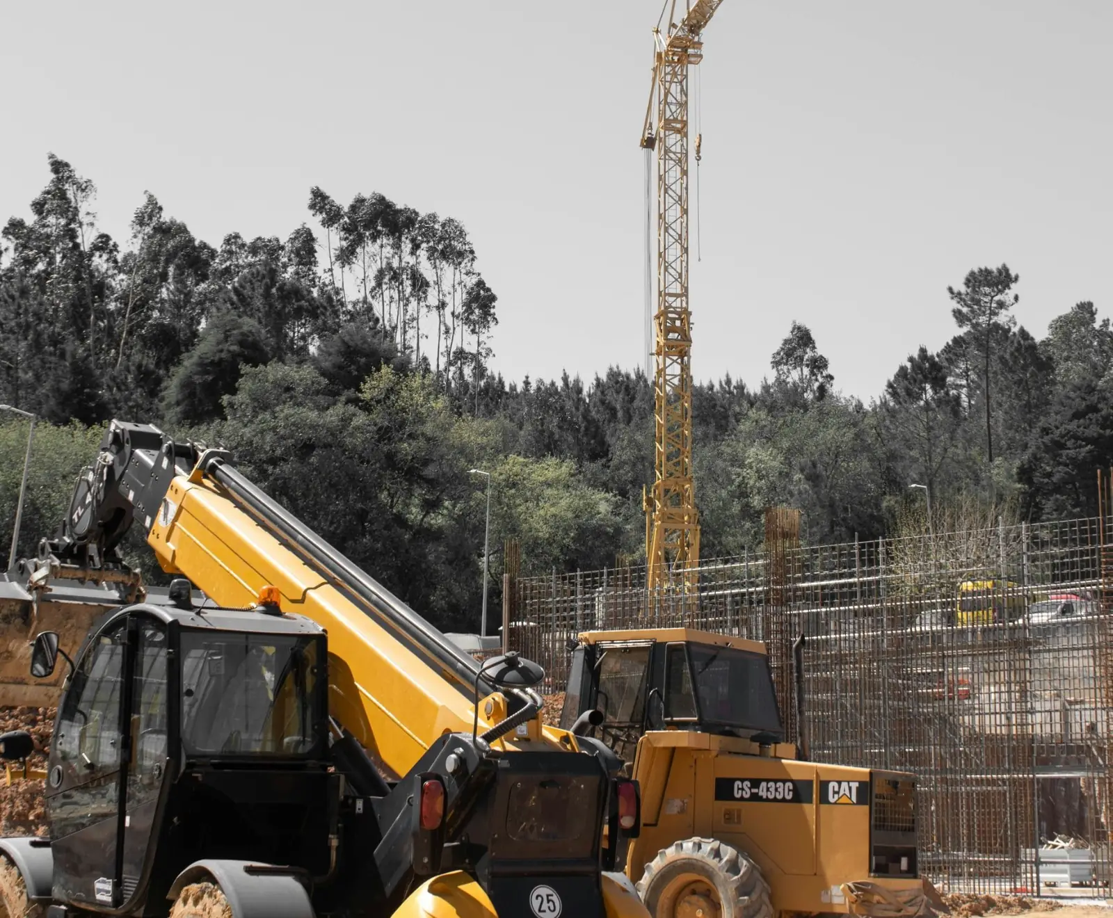 Photo of a telehandler and a loader on a construction site with a crane behind, for a Google Business Profile guide for contractors